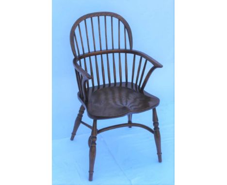 A THIRD QUARTER 20TH CENTURY REPRODUCTION DOUBLE COMB BACKED ARMCHAIR, with well figured solid seat, supported on four splaye