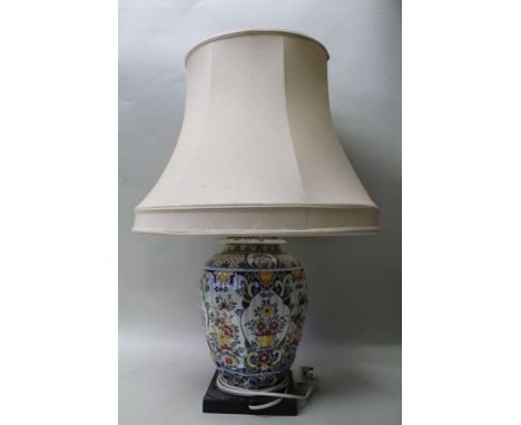 A DELFT GINGER JAR, converted to a table lamp on ebonised base, 34cm high (with shade)