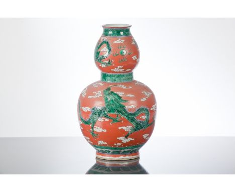 CHINESE 19TH CENTURY DOUBLE GOURD VASE
decorated with a dragon chasing a pearl in green against a red ground, 30cm high


