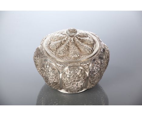 INDIAN WHITE METAL TEA CADDY
with lobed body and scrolling motifs overall, 11cm high 