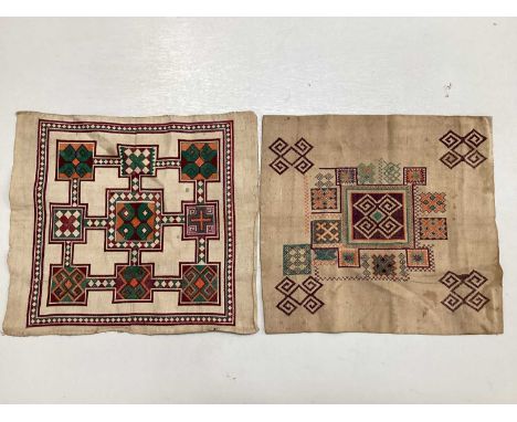 A selection of vintage textiles including an East European patchwork cover with geometric cross stitch panels connected with 