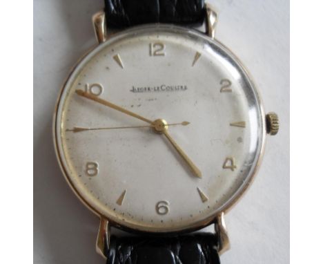A Jaeger LeCoultre 1956 gentleman's 9ct gold wrist watch, silvered round dial with applied alternating rose-gilt Arabic numer