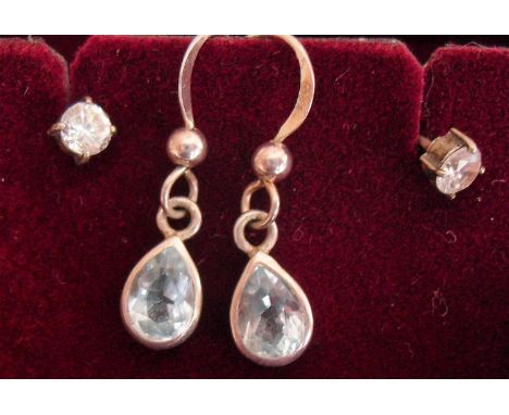 A lady's silver bangle, pair of silver-framed aquamarine earrings and another pair of silver earrings with cubic zirconia (3)