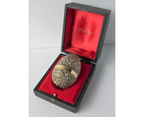 A Stuart Devlin hallmarked silver gilt limited edition novelty egg. The cover lifts to enclose a Jack in the Box, raised on g