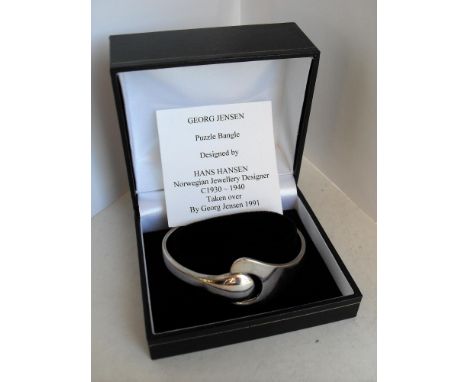 A boxed Georg Jensen silver .925 Puzzle Bangle designed by Hans Hansen, hallmarked to inside, as new 