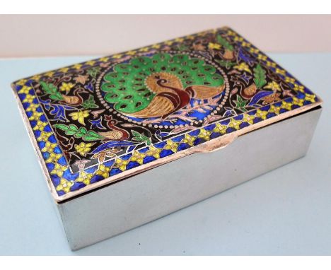 A champlevé decorated oblong white metal trinket box depicting a peacock in vitreous enamels to lid, marked 'SILVER' to base,