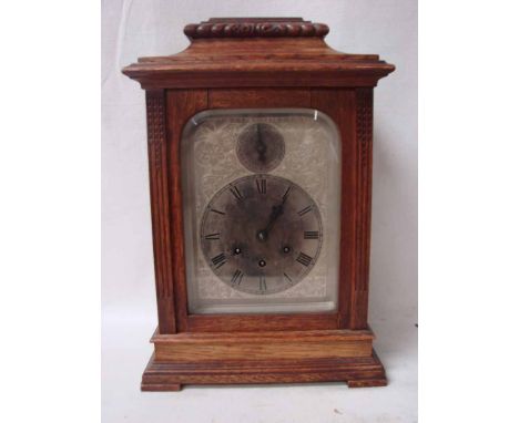 A Gustav Becker eight day mantle clock, housed in an oak case with pagoda top, silvered rectangular face and dial with Roman 