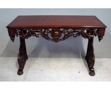 A Victorian Mahogany Console Table, moulded edge rectangular top above a carved and pierced frieze centred with a roundel fla