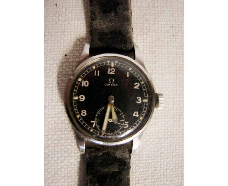 An Omega Military manual wind wrist watch, stainless steel case, black face with Arabic numerals, luminous hand and baton mar