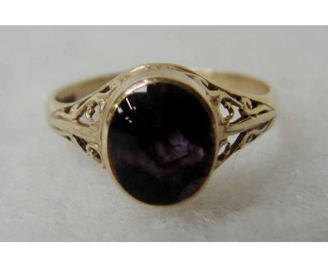 A 9ct gold ring with pierced scrollwork shoulders, set with a single Blue John stone of domed oval form, ring size R, 2.4g to