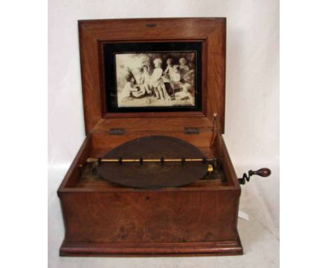 A 19th century German Symphonion, disc musical box, playing 13 5/8' steel discs over two combs, complete with winder, oak and