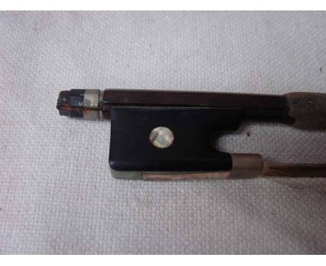 A violin bow, early 20th century, stamped Vuillaume a Paris, round stick, ebony and mother of pearl inlaid frog, 74cm long