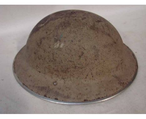 WW2 British Brodie Helmet with sand coloured camouflage as used in the North African desert. Shell stamped 1939 and EC & CO s