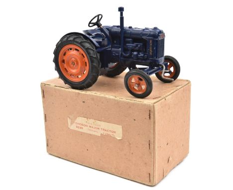 A Chad Valley clockwork Fordson Major tractor. In dark blue with orange wheels. With utility style card box with the remains 