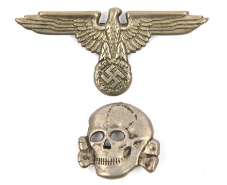 A Third Reich SS white metal cap eagle and skull, the former embossed with number 10 (Forsten &amp; Barth, Pforzheim), the la