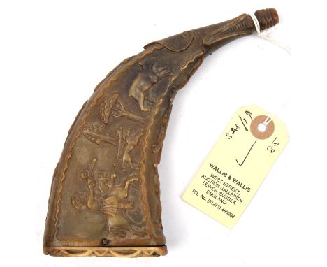 A 17th century pale flattened horn flask, deeply carved on one side with horseman and hounds pursuing a hare amid stylised tr