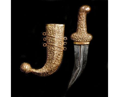 A small Indian dagger jambiya, c 1900  from Kutch, broad curved DE blade 10cms, gilt copper sheath and hilt embossed with flo