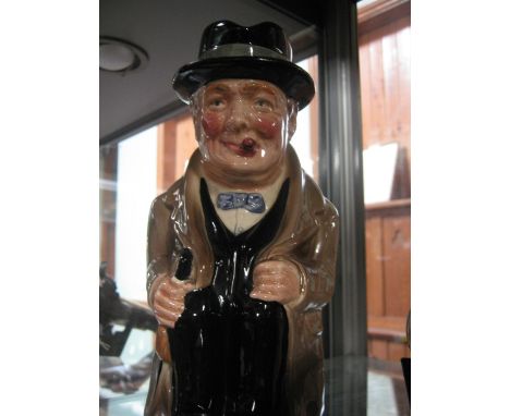 A Royal Doulton Toby jug "Winston Churchill", seated, smoking his habitual cigar, in evening dress, grey cloak and Homberg ha