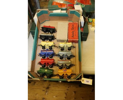 10 Hornby O gauge 4 wheel tank wagons. An early open lattice framed PRATTS in dark green, another later example in orange. A 