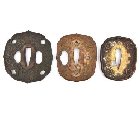 A brass tsuba from a WWII Japanese officer's sword; another of similar pattern but larger; and another tsuba. GC (3)         