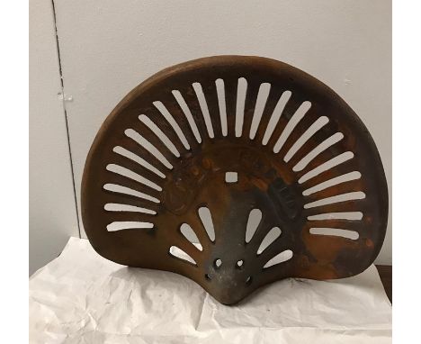 A Cast Iron rusty tractor seat