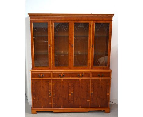 YEW GLAZED SIDE CABINETwith a moulded dentil cornice above four leaded glass doors with an illuminated interior and adjustabl