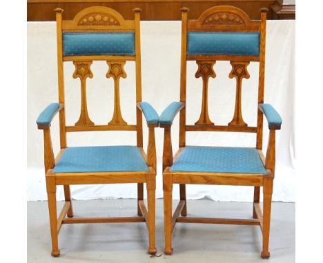 PAIR OF ART NOUVEAU OAK AND INLAID CARVER DINING CHAIRSwith a shaped carved top rail above a padded section with two stylized