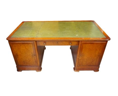WALNUT AND FIGURED WALNUT PARTNERS DESKwith a green tooled leather inset top above twin pedestals with cupboard doors to each
