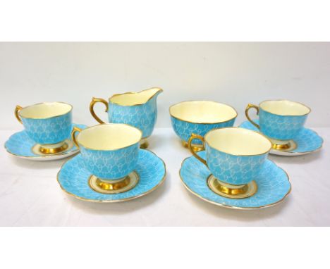 ROYAL ALBERT TEA SETdecorated in Royal blue with a white swirl and gilt border, comprising twelve tea cups and saucers, twelv