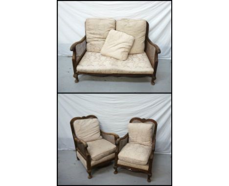 EDWARDIAN MAHOGANY BERGERE SUITEcomprising a two seat sofa and two armchairs, each with a caned shaped back with fan detail t