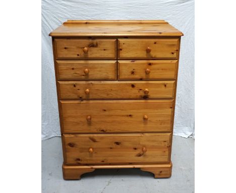 DUCAL WAXED PINE CHESTwith a shaped raised back and moulded top above four short panelled drawers and three long panelled dra