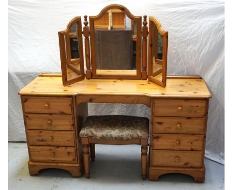 DUCAL WAXED PINE KNEEHOLE DRESSING CHESTwith an arrangement of nine drawers, 148cm wide, together with a pine triptych mirror