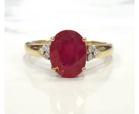 RUBY AND DIAMOND RINGthe central oval cut ruby approximately 1.6cts flanked by three small diamonds to each shoulder, on nine