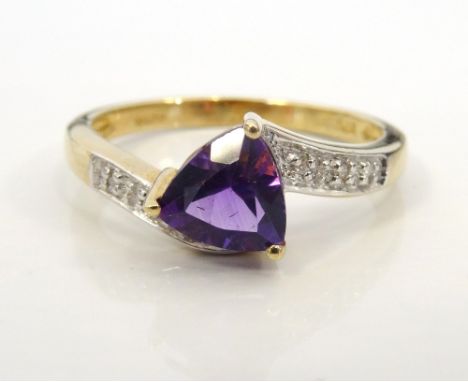 AMETHYST AND DIAMOND RINGthe central trillion cut amethyst flanked by diamond set twist shoulders, on nine carat gold shank, 