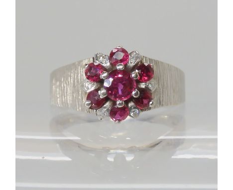 An 18ct white gold ruby and diamond cluster ring, finger size P1/2, weight 5.7gms Condition Report: Available upon request