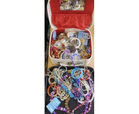 A large collection of vintage costume jewellery in a retro vanity case Condition Report: Not available for this lot