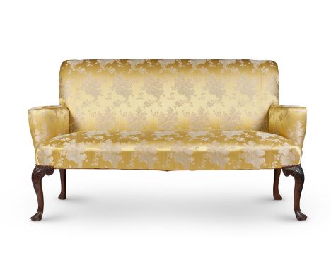 A MAHOGANY AND UPHOLSTERED SOFA IN GEORGE II STYLE19TH CENTURYWith rectangular padded back, outscrolled armrests and seat on 