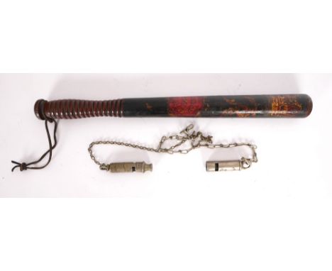 A Victorian decorated police truncheon and two Royal Irish Constabulary whistles. A 19th century turrned mahogany truncheon, 