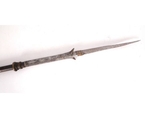 A 19th century Indian boar-hunting spear. The narrow, brass-inlaid steel, leaf-shaped blade with two, forward pointed barbs. 