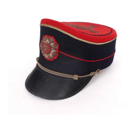 A mid 20th century Irish army infantry officer's full dress shako. The crimson crown and blue-black sides with crimson piping