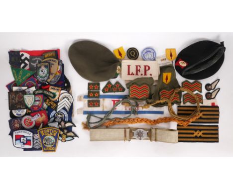 Irish Army uniform items and insignia. Two Oglaigh na h-Eireann uniform berets and a collection of rank insignia, shoulder fl
