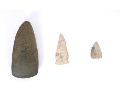 8th century AD polished stone axe head and two Clovis arrow heads. The axe head length 4.50in. (11.4cm) A gift from American 