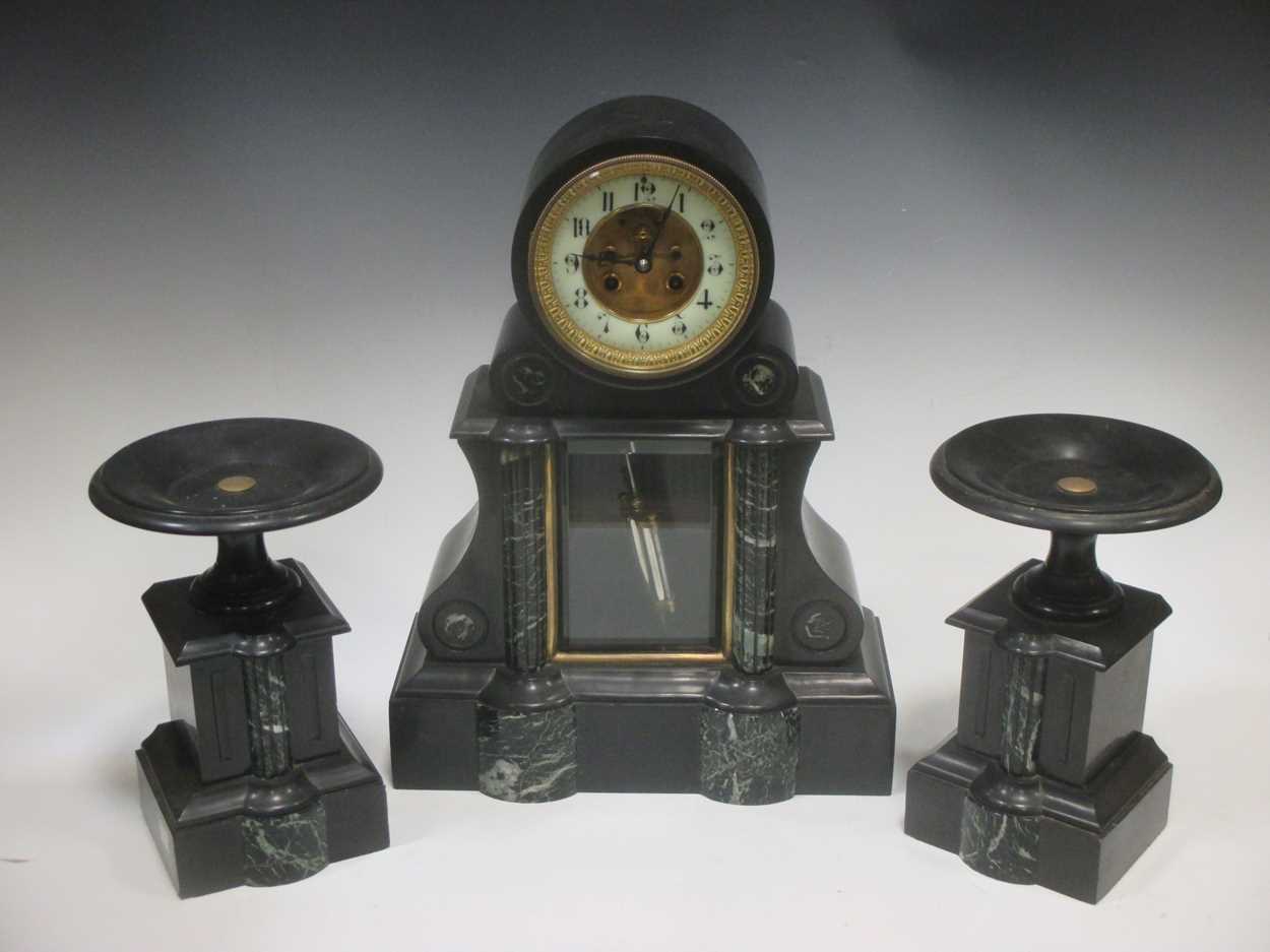 A late Victorian black marble clock garniture, 43cm high in Cheffins