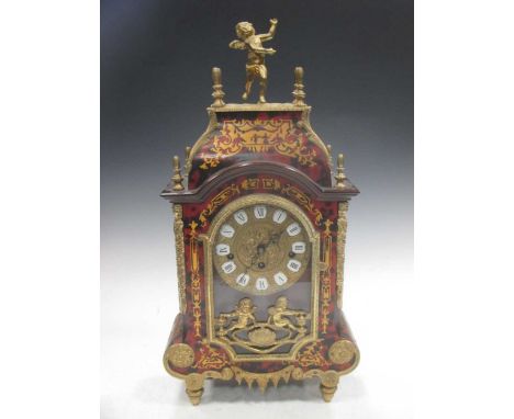 A Boulle mantel clock, surmounted by a cherub, 54cm high