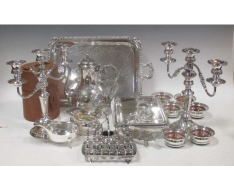 A large quantity of silver plated items including boxed flatware, entree dishes, coasters, candelabra, tray, kettle on a stan