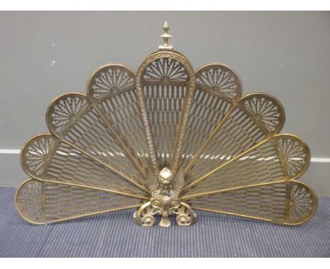A brass peacock tail fire screen, 63cm high