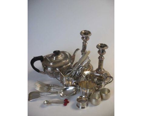 A quantity of silver plated wares including a pair of telescopic candlesticks, a three piece tea set and some flatware