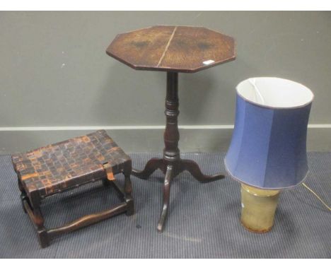 A 20th century oak stool with woven leather strap top together with an octagonal oak wine table and a glazed pottery lamp (3)