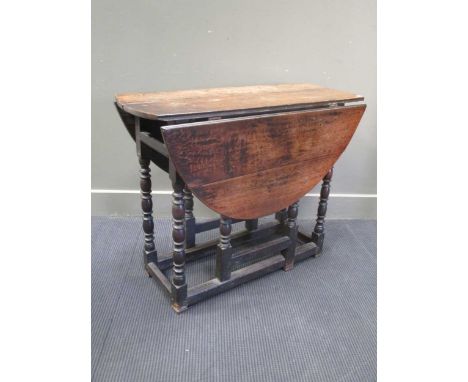 An oak oval drop leaf gateleg table, with bobbin turned legs,74 x 92 x 115cm wide extended