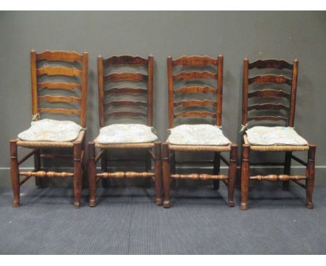 A set of four 19th century ladder back dining chairs with rush seats